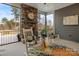 Inviting screened porch with stone fireplace, rocking chairs, and view of lush landscaping at 107 Hillside Cove Ct, Mooresville, NC 28117
