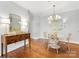 Charming dining room featuring a round table, stylish chairs, hardwood floors and elegant lighting at 1121 Park West Dr, Charlotte, NC 28209