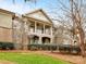 Beautiful condo exterior featuring brick and HardiePlank with covered porches and manicured landscaping at 1121 Park West Dr, Charlotte, NC 28209