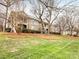 Exterior angle of condo building showcasing the well-manicured landscape and overall appeal at 1121 Park West Dr, Charlotte, NC 28209