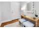 Entryway with light walls, hardwood floors, mirror, lamp, decorative table, and two stools at 1121 Park West Dr, Charlotte, NC 28209