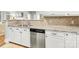 Modern kitchen with granite countertops, stainless steel dishwasher, and white cabinets at 1121 Park West Dr, Charlotte, NC 28209