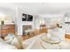 Open living area with a fireplace, hardwood floors, and comfortable seating that extends into the dining area at 1121 Park West Dr, Charlotte, NC 28209