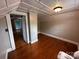Charming bedroom with sloped ceilings, hardwood floors, and access to additional space at 115 6Th Ne Ave, Hickory, NC 28601