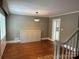 Inviting dining room with hardwood floors, a stylish light fixture, and stairway access at 115 6Th Ne Ave, Hickory, NC 28601