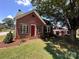 Charming red brick home with a well-manicured lawn and a classic red front door at 115 6Th Ne Ave, Hickory, NC 28601