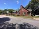 Charming red brick home with a well-manicured lawn and a classic red front door at 115 6Th Ne Ave, Hickory, NC 28601