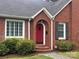 Elegant brick entryway with a striking red front door and stone pathway at 115 6Th Ne Ave, Hickory, NC 28601