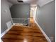 Upstairs hallway with hardwood floors, white trim, and neutral paint at 115 6Th Ne Ave, Hickory, NC 28601