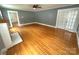 Inviting living room boasts hardwood floors, a white fireplace, and a view into another room at 115 6Th Ne Ave, Hickory, NC 28601