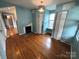 Bright living room featuring hardwood floors, a fireplace, and blue walls at 115 6Th Ne Ave, Hickory, NC 28601