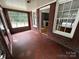 Charming sun room featuring brick floors and large window looking out to the street at 115 6Th Ne Ave, Hickory, NC 28601