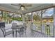Relaxing back porch area with a ceiling fan, providing a serene outdoor dining space and overlooking the backyard at 117 Maple Hill Rd, Monroe, NC 28110