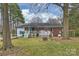 View of backyard featuring a deck, fire pit and spacious yard at 117 Maple Hill Rd, Monroe, NC 28110