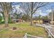 Aerial view of large backyard with sheds, lounge, fire pit and mature trees at 117 Maple Hill Rd, Monroe, NC 28110