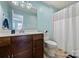 Bathroom featuring a vanity with sink, toilet, and shower with a shower curtain at 117 Maple Hill Rd, Monroe, NC 28110