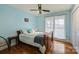 Bedroom with hardwood floors, a ceiling fan, and closet doors for storage at 117 Maple Hill Rd, Monroe, NC 28110