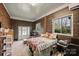 Bedroom with carpeted floor, wood paneled walls, two windows, and custom bed frame with storage at 117 Maple Hill Rd, Monroe, NC 28110