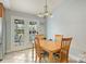 A sunny breakfast nook and dining area with French doors leading to screened porch at 117 Maple Hill Rd, Monroe, NC 28110
