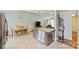 A kitchen with stainless steel appliances, tiled floors, and an island featuring granite countertops at 117 Maple Hill Rd, Monroe, NC 28110