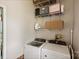 Functional laundry room featuring a modern, side-by-side washer and dryer and ample shelving for storage solutions at 117 Maple Hill Rd, Monroe, NC 28110