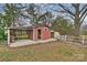 View of storage shed with covered seating area and an open door at 117 Maple Hill Rd, Monroe, NC 28110