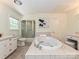 Bright bathroom featuring a large soaking tub, tiled surround, and separate shower at 124 Canterbury Ln, Matthews, NC 28104