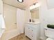 Bathroom featuring a shower/tub combo and vanity sink with ample storage space at 124 Canterbury Ln, Matthews, NC 28104