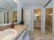 Bathroom featuring dual sinks, vanity and sink with an open doorway to the shower and toilet at 124 Canterbury Ln, Matthews, NC 28104