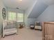 Bedroom with carpeted floors, a crib, and a rocking horse by the window at 124 Canterbury Ln, Matthews, NC 28104