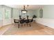 Inviting dining room with natural light, a statement chandelier, and a cozy rug creates a warm and welcoming atmosphere at 124 Canterbury Ln, Matthews, NC 28104
