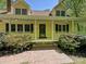Inviting front entrance featuring a brick walkway, decorative bushes, and a covered porch with black shutters at 124 Canterbury Ln, Matthews, NC 28104
