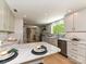 Bright kitchen features stone countertops, stainless steel appliances, and modern cabinets at 124 Canterbury Ln, Matthews, NC 28104