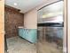 The kitchenette area showcases blue cabinets, stainless steel fridge, and brick accents at 124 Canterbury Ln, Matthews, NC 28104