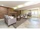 Cozy living room featuring a brick fireplace, gray couch, sitting chairs, and open dining area at 124 Canterbury Ln, Matthews, NC 28104