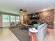 Bright living room features a stone fireplace, wood floors, and a ceiling fan for added comfort at 124 Canterbury Ln, Matthews, NC 28104