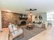 Living room featuring a stone fireplace, wooden floors, neutral furniture, and ample natural light at 124 Canterbury Ln, Matthews, NC 28104