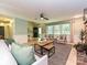 Bright living room featuring a stone fireplace, wood floors, and multiple windows providing ample natural light at 124 Canterbury Ln, Matthews, NC 28104