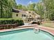 Inviting pool with wooden deck and ladder in a private backyard setting at 124 Canterbury Ln, Matthews, NC 28104