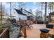 Expansive backyard deck featuring a hot tub, pergola, fire pit, and outdoor seating at 125 High Sail Ct, Mooresville, NC 28117