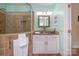 A well-lit bathroom features a tiled shower with glass enclosure and vanity with granite countertop and towel warmer at 125 High Sail Ct, Mooresville, NC 28117