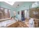 Bathroom features a soaking tub with a skylight and a tiled walk-in shower at 125 High Sail Ct, Mooresville, NC 28117