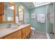 Bathroom featuring double vanity, tile floor, and shower with glass door at 125 High Sail Ct, Mooresville, NC 28117