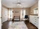 A neutral bedroom features hardwood floors, two windows with white curtains, and is furnished with a crib and dresser at 125 High Sail Ct, Mooresville, NC 28117