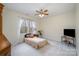 Bedroom features natural light, neutral paint, a ceiling fan, and carpeted floors at 125 High Sail Ct, Mooresville, NC 28117
