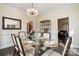 Elegant dining room featuring a glass table, six chairs, modern chandelier, and views to the living room at 125 High Sail Ct, Mooresville, NC 28117