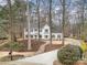 Beautiful home with a winding driveway and lush landscaping nestled among mature trees for added privacy at 125 High Sail Ct, Mooresville, NC 28117