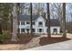 Beautiful home with mature trees, walkway, manicured flower beds, and a lovely front yard creating inviting curb appeal at 125 High Sail Ct, Mooresville, NC 28117