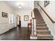 Inviting foyer with hardwood floors, staircase, and elegant decor at 125 High Sail Ct, Mooresville, NC 28117
