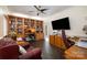 A home office with hardwood floors, a ceiling fan, built-in shelving, and a tv at 125 High Sail Ct, Mooresville, NC 28117